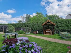 a gazebo in a yard with a horse in the background at Mac Shack Cottage in Ashen