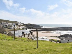 a view of a beach with houses and the ocean at Seaton Cottage in Collieston