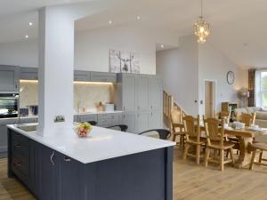 a kitchen and dining room with a table and chairs at The Hemmel in Greenhaugh