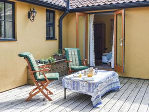 a patio with a table and chairs on a porch at Bradcar Farm Cottage in Snetterton