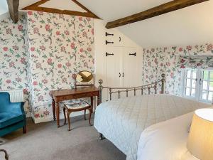 a bedroom with a bed and a table with a mirror at Sandfold Farm in Newby Bridge
