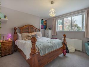 a bedroom with a wooden bed and a window at Vallance House in Brighton & Hove