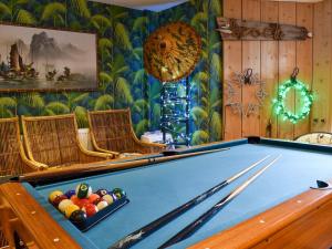 a room with a pool table and chairs at Fronks House in Harwich