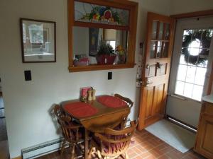 a dining room with a wooden table and chairs at Relax in Nature & Serenity at Bird River Cottage! in Middle River