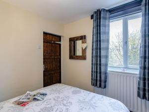 a bedroom with a bed and a window at The Miners Rest in Middleton