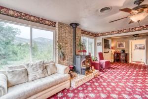 a living room with a couch and a fireplace at A Bed of Roses in Oakhurst