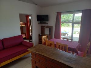 a living room with a couch and a table at El Atardecer in Cortaderas