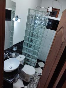 a bathroom with a sink and a toilet and a mirror at San José de las bromelias in Marinilla