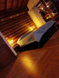 a bed in a room with lights on the floor at San José de las bromelias in Marinilla
