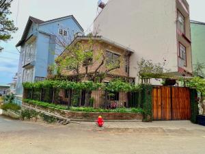 a red fire hydrant in front of a house at Nhà An Cozy in Da Lat