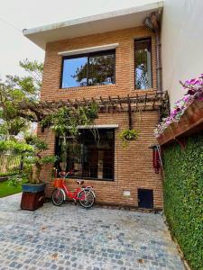 a red bike parked in front of a brick building at Nhà An Cozy in Da Lat