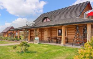 a log cabin with a picnic table in front of it at Awesome Home In Jezierzany With Outdoor Swimming Pool in Jezierzany