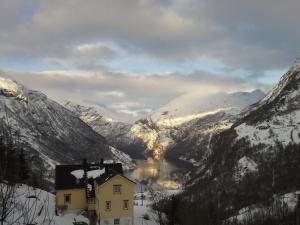 a house in the middle of a snowy mountain at Lunheim in Geiranger in Geiranger