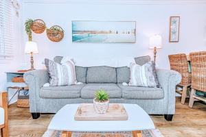 a living room with a couch and a table at Seaward Escape - Cherry Grove Beach in Myrtle Beach