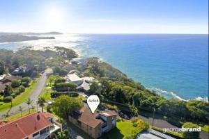 an aerial view of a house next to the ocean at ELEGANT LUXURY, STUNNING SEA VIEWS-see whales pass in Avoca Beach