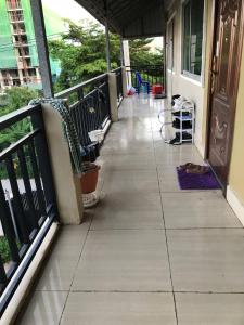 a porch with a tile floor and a railing at 88 Apartment Sen Sok in Phnom Penh