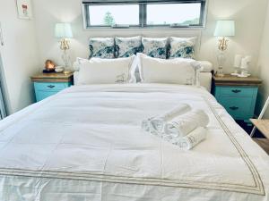 a bedroom with a large white bed with pillows at Sunrise @ Rye in Rye