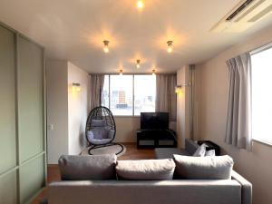 a living room with a couch and a chair at Hotel Yuzuki in Takamatsu