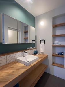 a bathroom with a sink and a mirror at Hotel Yuzuki in Takamatsu
