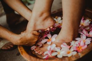 two people with their feet in a bowl of flowers at Pura Vida Beach & Dive Resort in Dauin