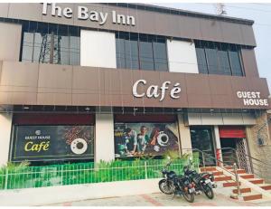a building with two motorcycles parked in front of it at Hotel The Bay Inn, Konark in Pānchagān
