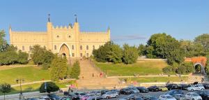 a parking lot in front of a large building at Apartament Lubelski Zamkowy in Lublin