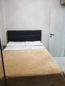 a bed with a black headboard in a bedroom at D&B Apartment 3 in Paralia Katerinis