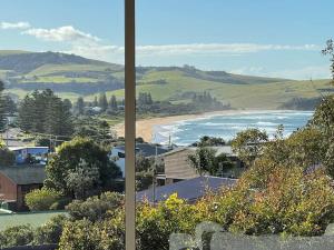 a view of the ocean and a beach with houses at Seaview at Gerringong - 4pm check out if available in Gerringong