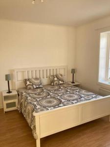 a bedroom with a large bed with two night stands at Entire Town House on Ground floor front of Lake in Märsta