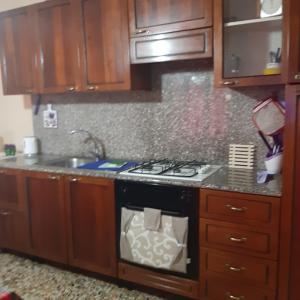 a kitchen with a stove and a sink at Residenza la Viola in Casaprota