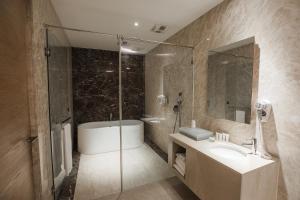 bagno con vasca, lavandino e doccia di Motel Stars a Taichung