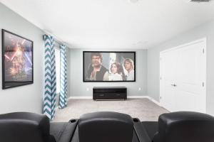 a living room with a flat screen tv on a wall at Champions Gate Resort, Game Room, Theater, Miles From Disney! in Davenport