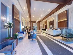 a lobby of a hotel with blue chairs and tables at Modern style room with sky pool 古城边天际泳池公寓 in Chiang Mai +52 photos