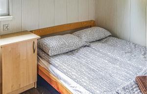 a bed in a small room with a wooden frame at Nice Home In Biskupiec With Kitchen in Biskupiec