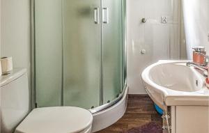 a bathroom with a shower and a toilet and a sink at Awesome Home In Biskupiec With 2 Bedrooms in Biskupiec