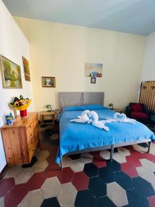 a bedroom with a bed with towels on it at B&B Galileo Galilei in Caserta