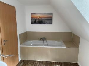 a bathroom with a bath tub in the attic at Ferienhaus Groß Grönau in Groß Grönau