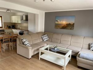 a living room with a couch and a table at Ferienhaus Groß Grönau in Groß Grönau