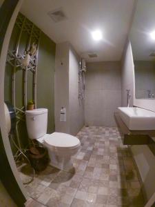 a bathroom with a toilet and a sink at Baan Nai Soi Mini Hotel in Chiang Mai