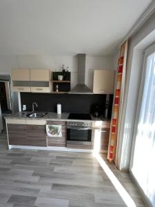 a kitchen with a sink and a stove at Apartment 1 Gäste in Schörfling