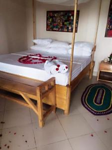 a bedroom with two bunk beds with white sheets at Mwanza lake view FARM Eco LODGE in Sengerema