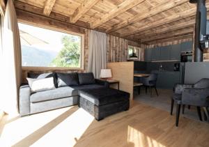 a living room with a couch and a table at Chalet Tschogerhof Tiers am Rosengarten Dolomiten in Tires