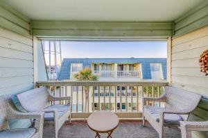 a balcony with two chairs and a table at Oceanside 308-B in Isle of Palms