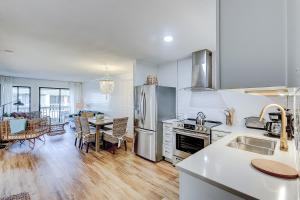 a kitchen with stainless steel appliances and a dining room at Oceanside 308-B in Isle of Palms
