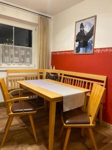 uma sala de jantar com uma mesa de madeira e cadeiras em Apartment Emma em Mayrhofen