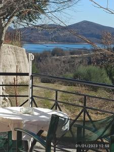 a table and chairs with a view of a lake at ΡΑΧΗ in Kerasea