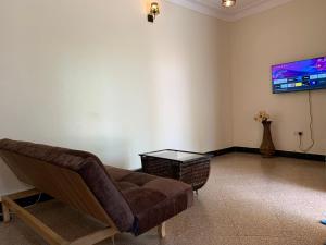 a living room with a couch and a flat screen tv at Green Haven in Mbale