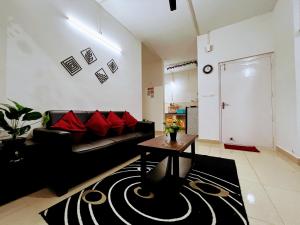 a living room with a black couch and red pillows at Mesmerizing comfy condo with world class amenities in Manipala