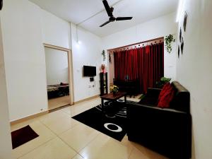 a living room with a couch and a table at Mesmerizing comfy condo with world class amenities in Manipala
