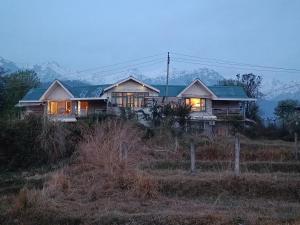 a house sitting on top of a hill at Chinarchalet in Pālampur